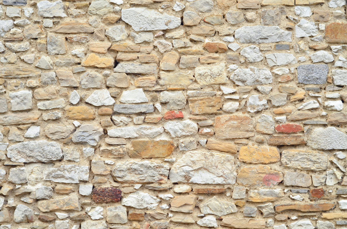 Mur en pierres multicolores, photographie haute résolution d'un mur de vieille bâtisse composé de pierres différentes
